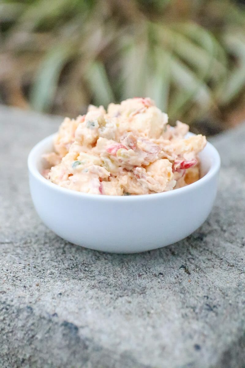 White Cheddar Bacon Pimento Cheese in a white bowl.