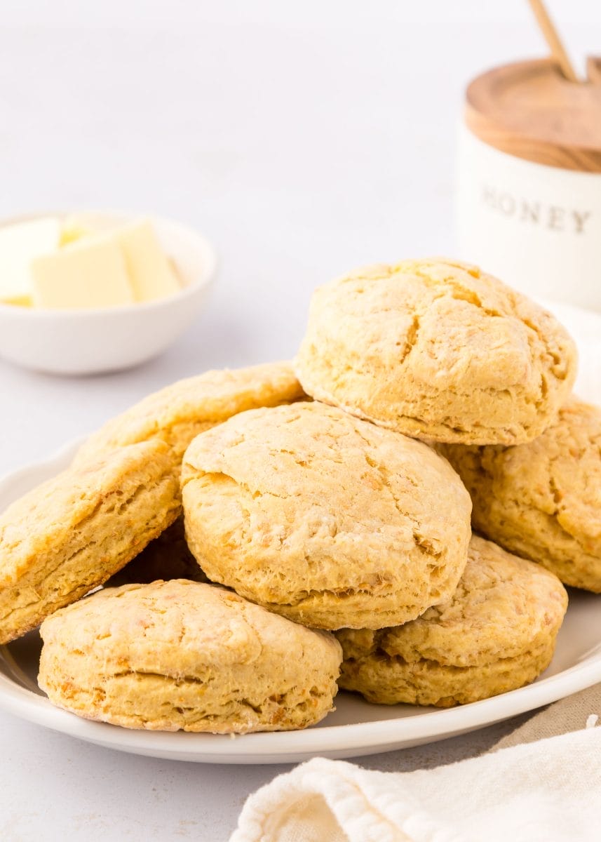 A pile of Sweet Potato Biscuits on a white plate.